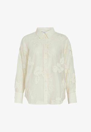 Blusa de manga larga color crema con bordado floral sutil, cierre de botones al frente, cuello clásico y puños anchos.