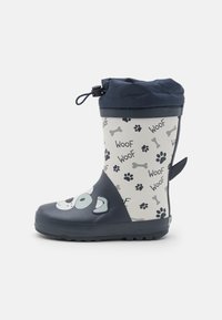 Botte de pluie en caoutchouc avec un haut bleu foncé et un corps gris clair ornés d'un visage de chien, d'empreintes de pattes et de motifs d'os. Haut ajustable avec une languette de tirage.