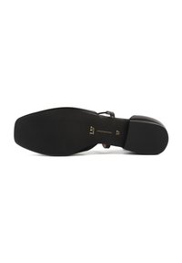Black leather shoe sole with a rectangular shape, smooth texture, and a slight curve. Features a small embossed size label in gold.