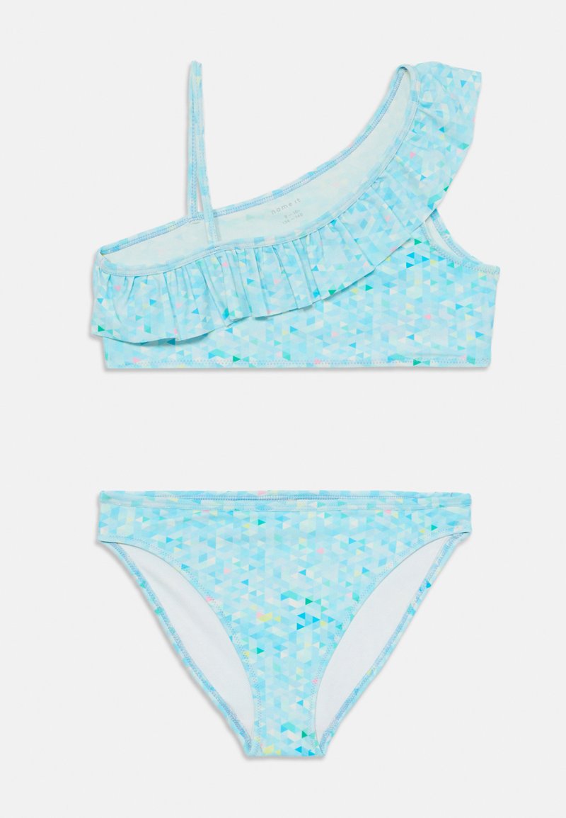 A two-piece bikini set featuring a light blue top with a ruffled design and one strap, and matching geometric-patterned bottoms.