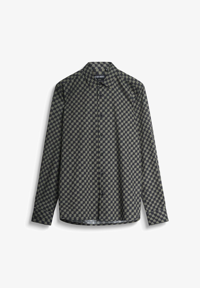 Camisa de manga larga en tonos oscuros con un patrón geométrico de círculos claros y oscuros alternos, confeccionada en una tela suave y con un cuello clásico.