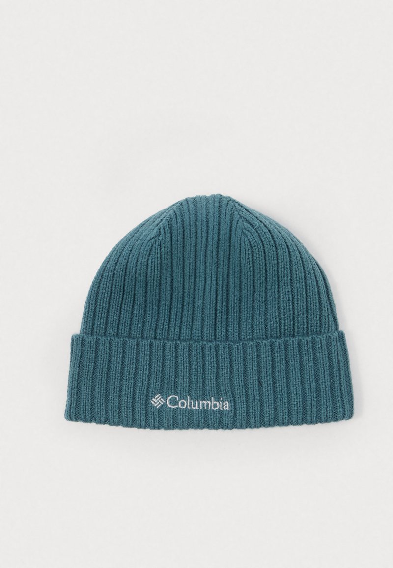 Beanie lavorato a maglia color teal con texture a coste e un bordo pieghevole. Presenta un logo Columbia bianco sul davanti. Tessuto morbido e elasticizzato.