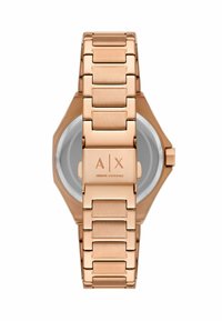 Reloj de acero inoxidable color oro rosa con caja octagonal, brazalete de eslabones y logotipo grabado en el cierre. Cristal transparente que revela la esfera.