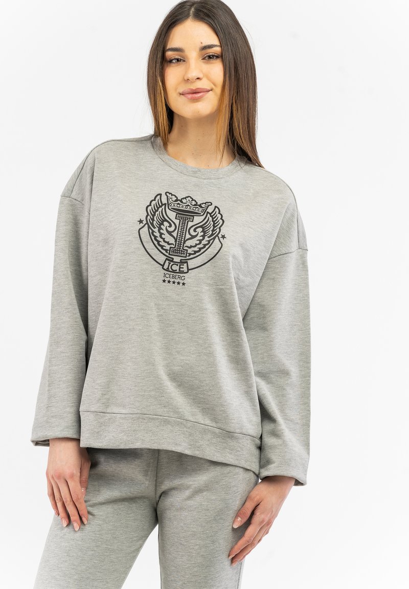 Gray sweatshirt with a round neckline, loose fit, and ribbed hem. Features a black graphic logo with wings on the front. Soft texture.