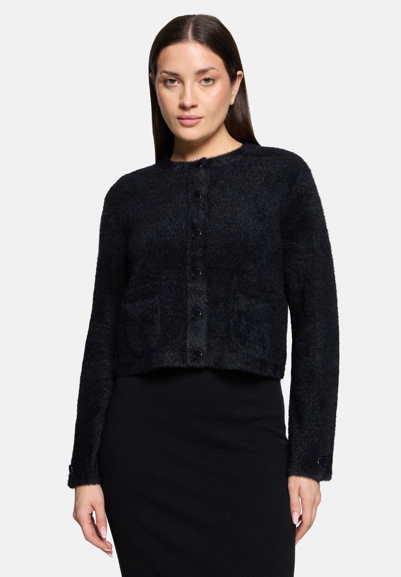 Czarny krótkowłosy kardigan o miękkiej, puszystej fakturze; okrągły dekolt; zapięcie na guziki z przodu; dwie przednie kieszenie; długie rękawy.