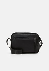 Borsa a tracolla nera con texture a granelli, forma rettangolare, chiusura con zip superiore e tracolla. Logo "Armani Exchange" visibile sul fronte.