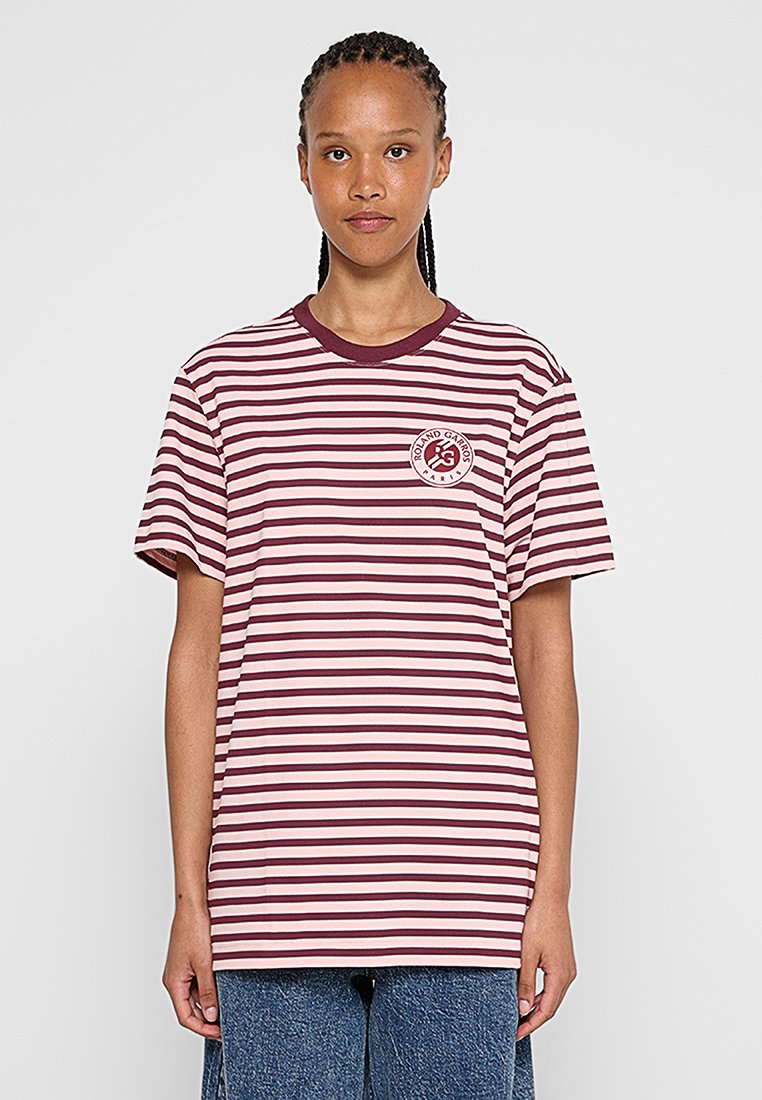 Gestreiftes T-Shirt in Pink- und Burgundy-Tönen, mit einem runden Ausschnitt und einem grafischen Logo, das auf der linken Brust aufgedruckt ist. Mit kurzen Ärmeln.