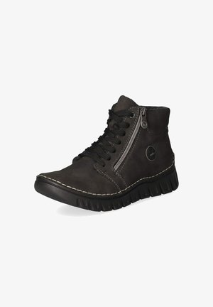 Bottine noire à cheville avec semelle épaisse en caoutchouc, fermeture éclair latérale, lacets noirs, coutures blanches et logo rond sur le côté extérieur près du talon.