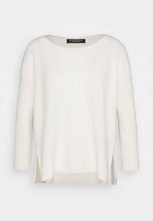 White knit sweater with a relaxed fit, featuring a rounded neckline, long sleeves, side slits, and a herringbone pattern texture.