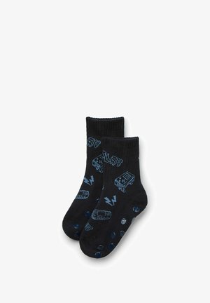 Calzini neri da crew con design grafici blu di una cassetta e fulmini, caratterizzati da una texture liscia e accenti a pois in contrasto.