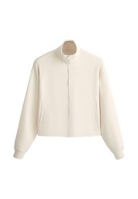 Giacca crema con zip, colletto alto, maniche lunghe, polsini elasticizzati e due tasche verticali frontali.