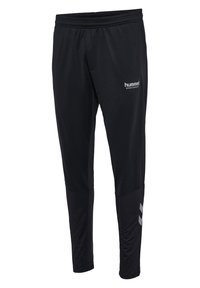 Zwarte sportieve broek van synthetisch materiaal. Kenmerken een elastische tailleband, taps toelopende pijpen en een reflecterend logo op de dij.