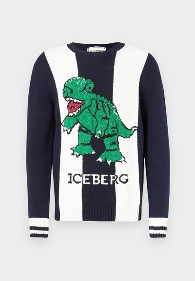 Μπλε σκούρο και άσπρο ριγέ πουλόβερ με γραφικό πράσινου δεινόσαυρου που βρυχάται και κείμενο «ICEBERG» στο μπροστινό μέρος, με ριμπ μανσέτες με λευκές ρίγες.