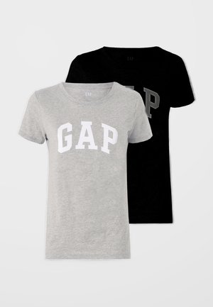 Two short-sleeve t-shirts, one grey with a white "GAP" logo, and one black with a grey logo. Both are made of soft cotton fabric.