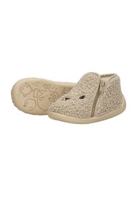 Beige fur-textured slippers with a zip closure and soft inner lining. Features rubber outsole with cute character patterns on the bottom.