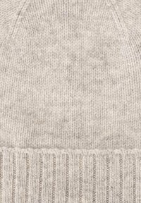 Light gray knitted beanie made from soft wool. Features a smooth texture with a ribbed cuff and a seamless, rounded top design.