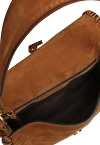 Brown suede handbag with a smooth texture, an interior zip pocket, and a sleek design. Features a sturdy strap and gold-tone hardware.