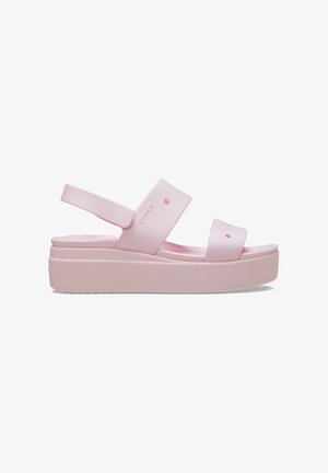 Roze plateausandalen van synthetisch materiaal met brede banden en een gevormde voetbed. Voorzien van afgeronde accenten en een gestructureerde zool.