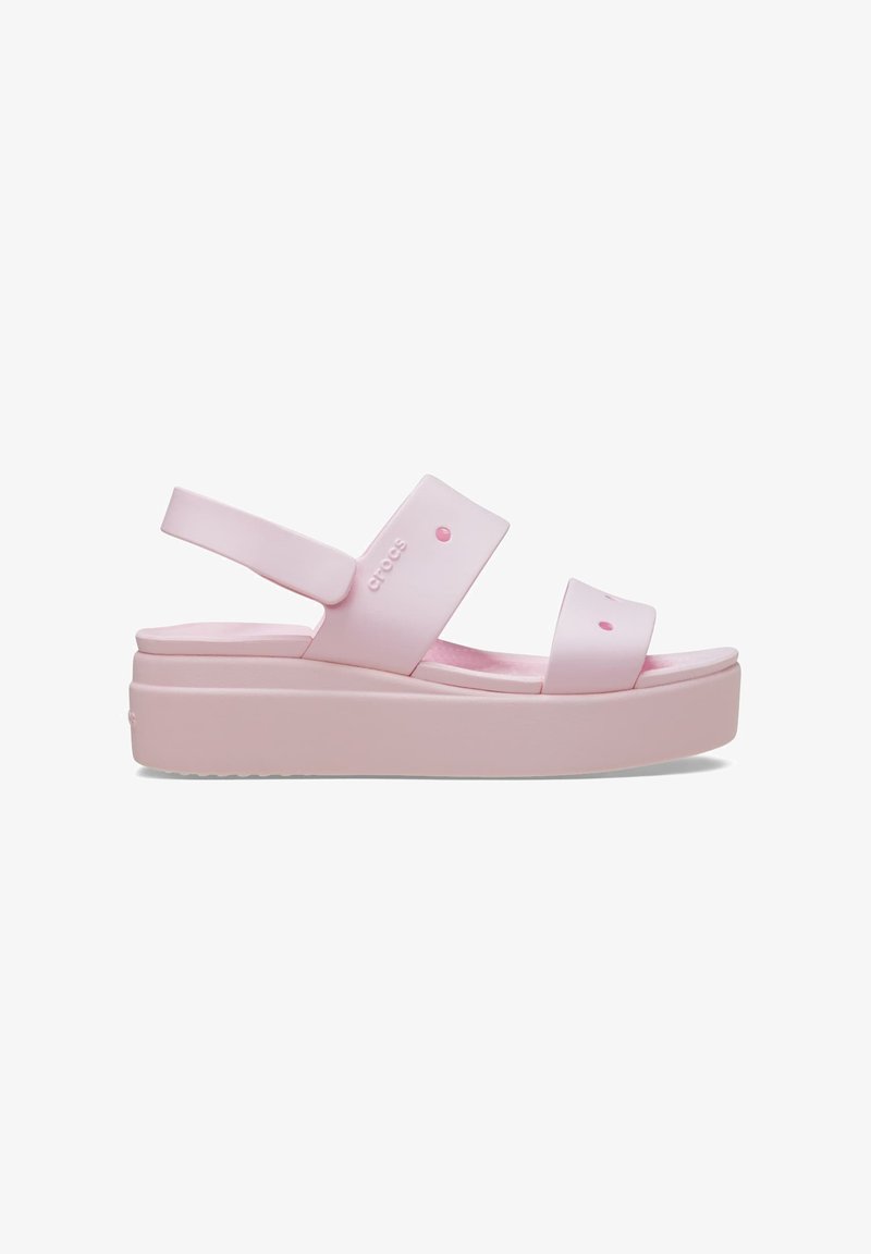 Pink platform sandals made of synthetic material with wide straps and a contoured footbed. Features rounded accents and a textured sole.
