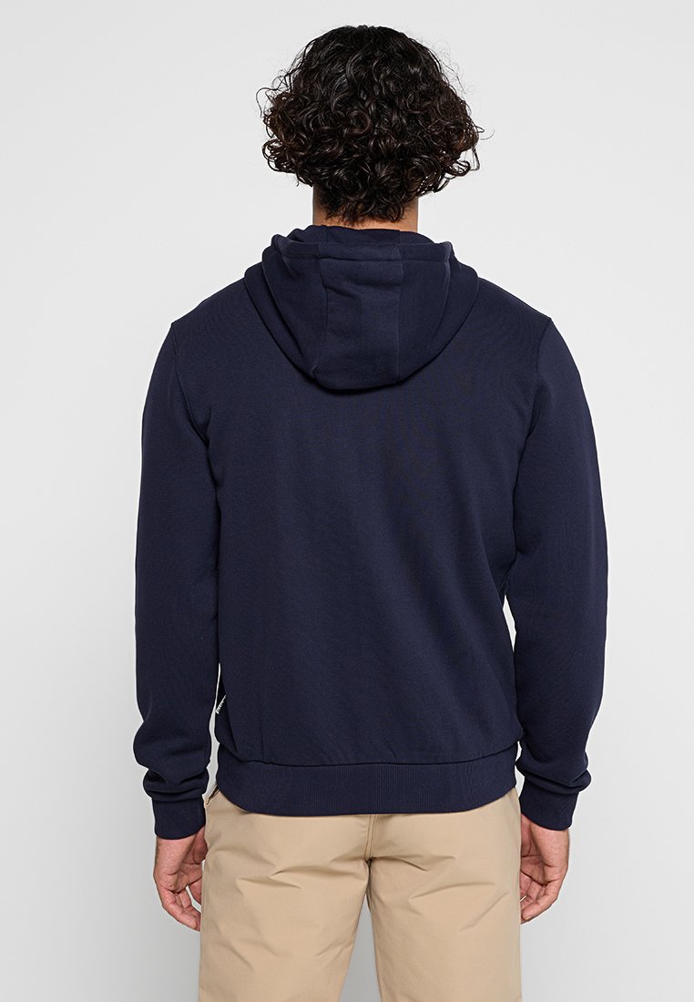 Marineblaue Kapuzenjacke mit gerippten Bündchen und Saum, aus einem weichen Stoff. Sie verfügt über eine Kängurutasche und eine sichtbare Zugkordel.