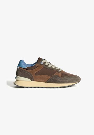 Brown suede sneaker with a smooth midsole, textured overlays, light blue accents, and beige laces. Side view showcases layered design.
