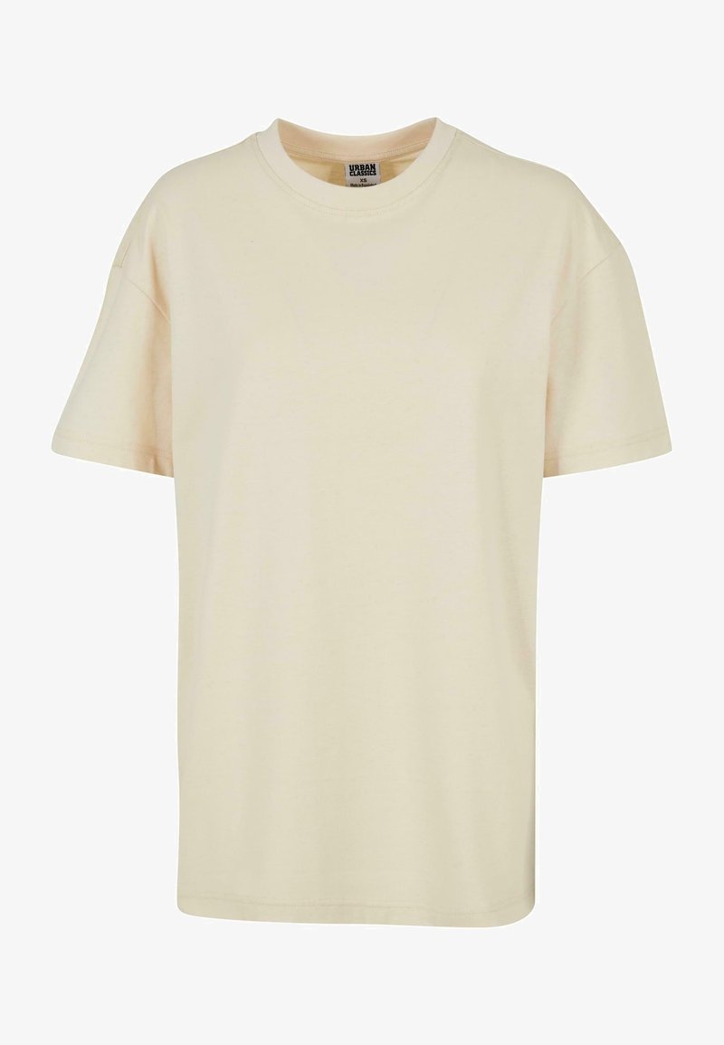 Beige bomull t-shirt med rund hals, kort ärm, boxig passform och en mjuk textur. Inga mönster eller utsmyckningar.