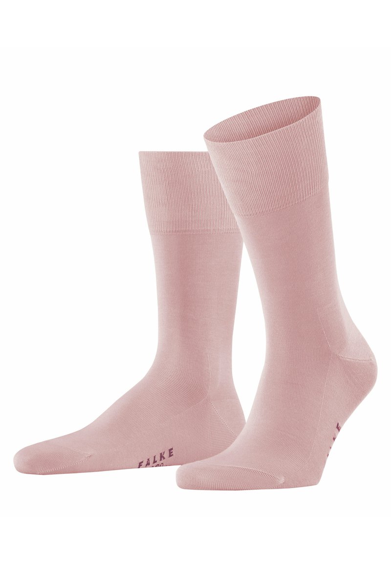 Chaussettes rose pâle en matériau lisse, avec un bord côtelé et une pointe sans coutures, portant l'inscription "FALKE" en violet sur le côté.