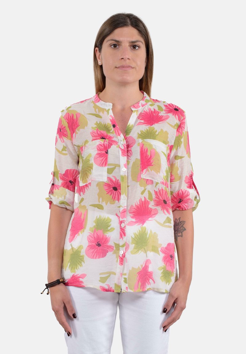 Camicia a stampa floreale in tessuto leggero con fiori di ibisco rosa e verdi, chiusura a bottoni sul davanti, colletto e maniche arrotolate.