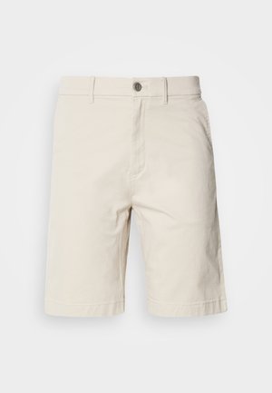 Μπεζ βαμβακερές σορτς με ίσια γραμμή, που διαθέτουν κλείσιμο μπροστά με κουμπί και φερμουάρ, πλαϊνές τσέπες και ραμμένα στριφώματα.