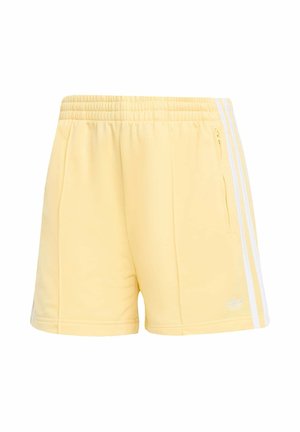 Světle žluté sportovní šortky z měkké látky s bílými bočními pruhy a kapsou na pravé straně se zipem.