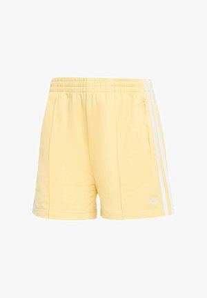 Světle žluté sportovní šortky z měkké látky s bílými bočními pruhy a kapsou na pravé straně se zipem.