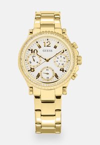 Gold-tone chronograph watch with a white dial, three sub-dials, gold hour markers, and crystal accents around the bezel. Metal bracelet.