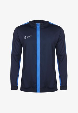 Giacca zip-up blu navy con pannelli laterali blu, maniche lunghe e collo tondo. Presenta un logo Nike bianco sul petto. Realizzata in tessuto morbido.