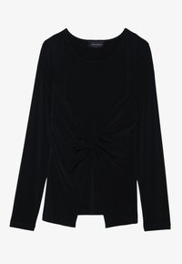 Svart langermet topp i myk, elastisk stoff med vridd frontdesign og rund halslinning. Merket sier "ANNA FIELD."