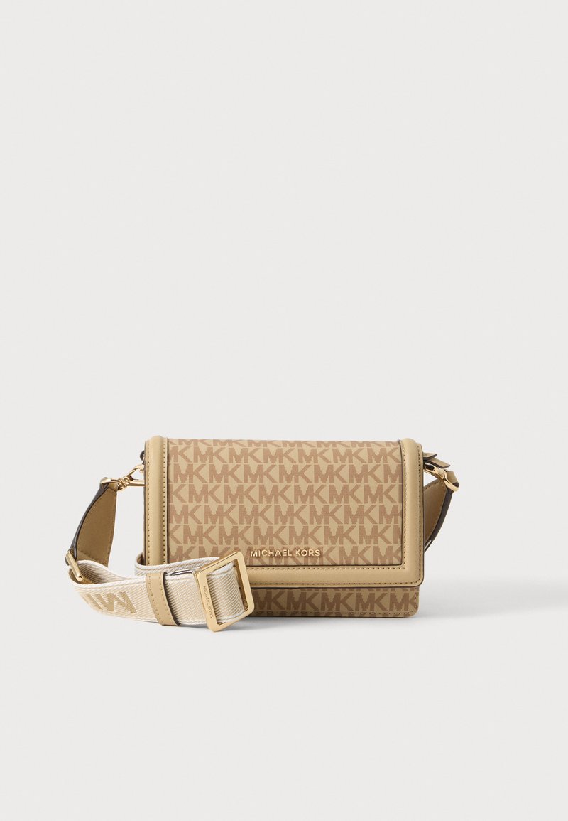 Μπεζ τσάντα χιαστί Michael Kors με ανάγλυφο μοτίβο MK, χρυσή πλακέτα με λογότυπο και ρυθμιζόμενο φαρδύ υφασμάτινο λουράκι με χρυσή αγκράφα.