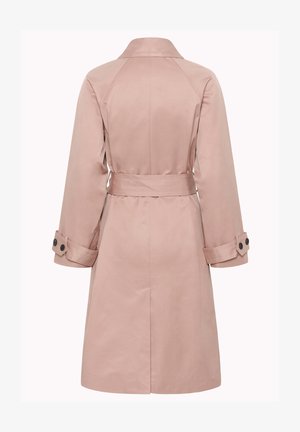 Gaiši rozā ceļgalu garuma trančmētelis ar vidukļa jostu un piespraužamām aprocēm, redzams no aizmugures uz vienkārša fona.