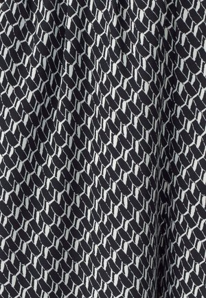 Black fabric with a white geometric pattern resembling interlocking shapes, featuring a smooth texture and consistent design throughout.