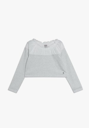 Top corto a maniche lunghe grigio chiaro con scollo a volant bianco e texturizzato. Presenta un tessuto liscio e un piccolo dettaglio con logo vicino all'orlo.