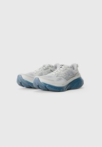 Light gray running shoes with breathable mesh uppers and thick blue cushioned soles, angled to show front and outer sides.