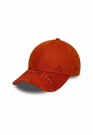 Rust orange baseball cap with distressed details and embroidered lettering on the curved brim and side logo.