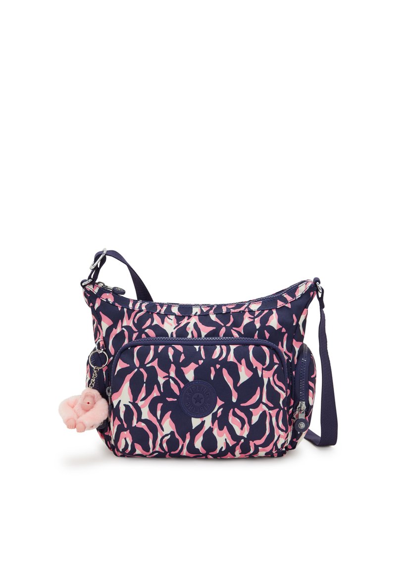 Navy and pink patterned crossbody bag with a rounded shape, zipper closures, fabric material, and a plush charm accessory.