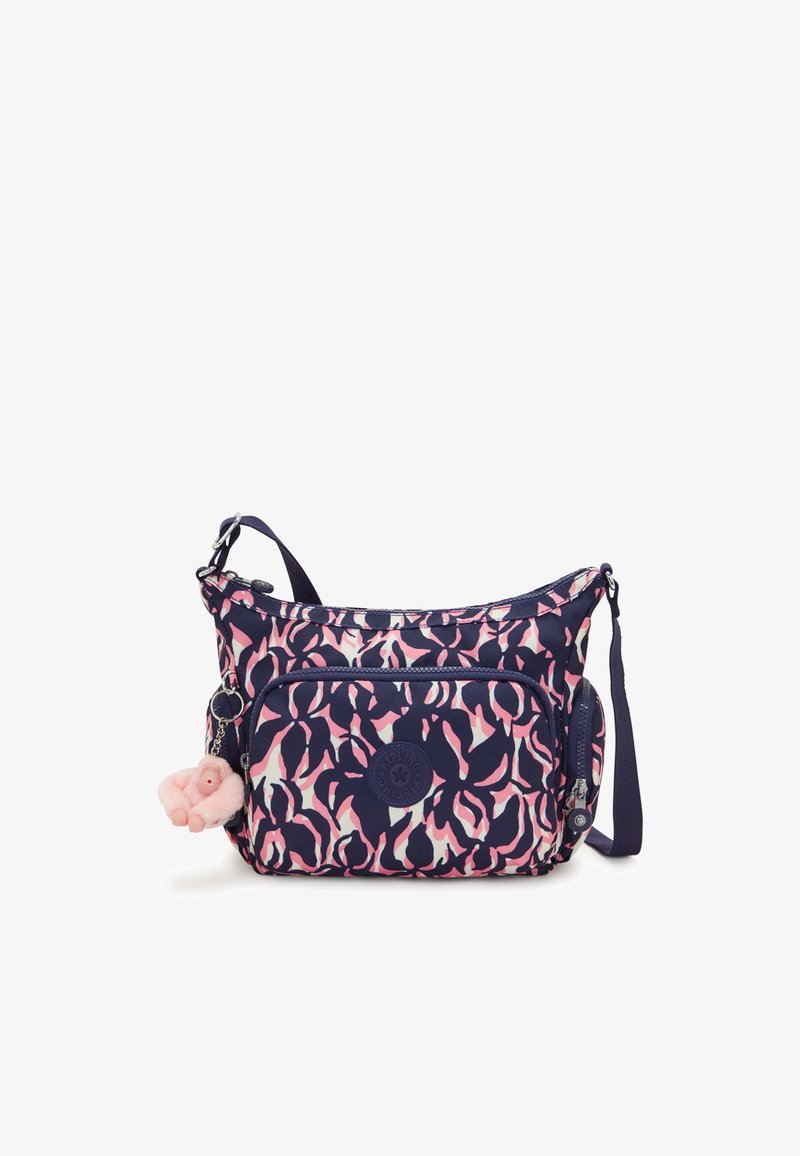 Navy and pink patterned crossbody bag with a rounded shape, zipper closures, fabric material, and a plush charm accessory.