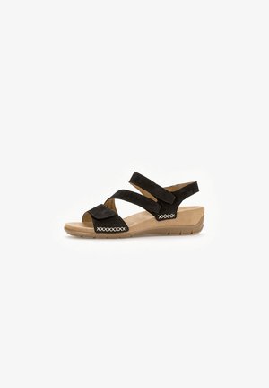 Black suede sandal with crisscross straps and elastic inserts. Cushioned footbed and rubber outsole. Accent stitching on straps.