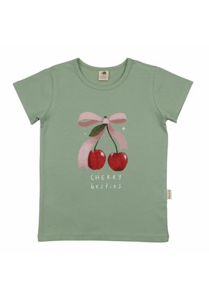 Light green children's t-shirt with two red cherries tied by a pink ribbon and the text "CHERRY besties" below.