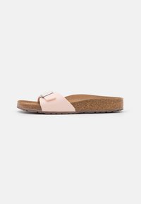 Pink slide sandal with a soft fabric upper and a metallic buckle, featuring a contoured cork footbed and textured rubber sole.