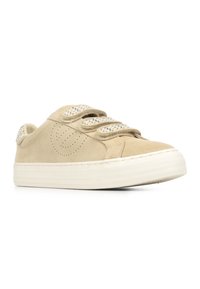 Beige suede sneakers with three velcro straps, textured white rubber sole, and perforated detailing on the sides.