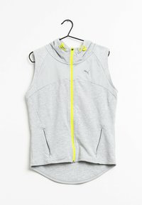 Sudadera sin mangas gris con cremallera frontal, que presenta un diseño de malla en la parte superior y acentos en amarillo neón, incluyendo la cremallera y los cordones.