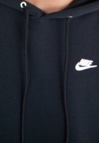 Black cotton hoodie featuring a drawstring, ribbed cuffs, and a white Nike logo on the left side of the chest.