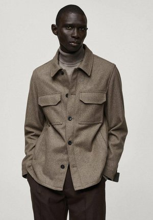 Brown wool blend jacket with two chest pockets, button closure, and a collared neckline. Smooth texture, relaxed design, suitable for layering.