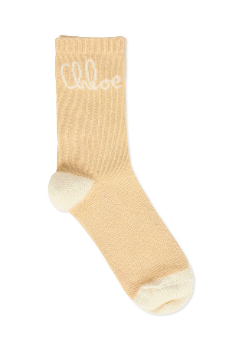 Calzino beige chiaro con una texture a costine, punta e tallone bianchi. Presenta il logo "Chloe" in bianco su tutto il corpo.